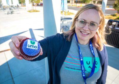 Umo team member holding cupcake