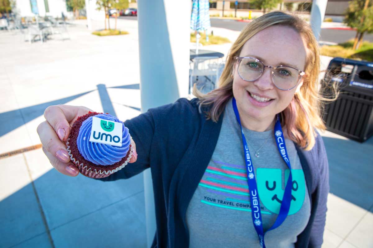 Umo team member holding cupcake