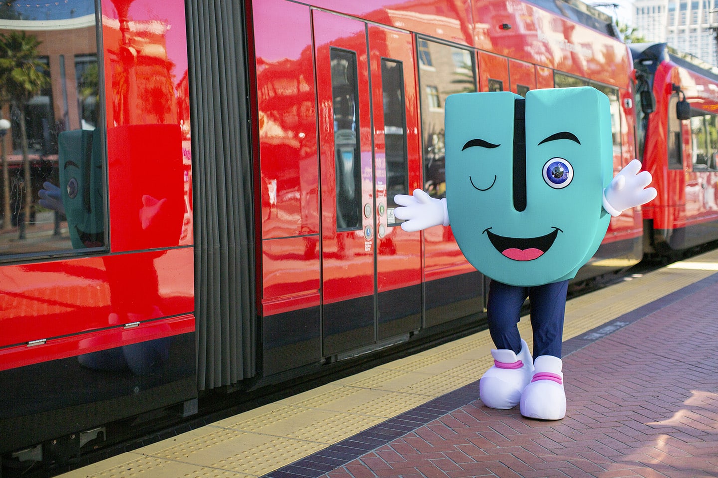 Umo mascot next to trolley